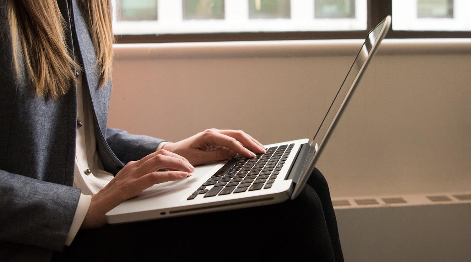 Close up image of a woman using her laptop.