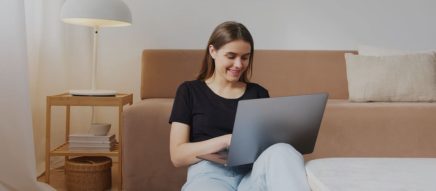Image of a young woman using a laptop.