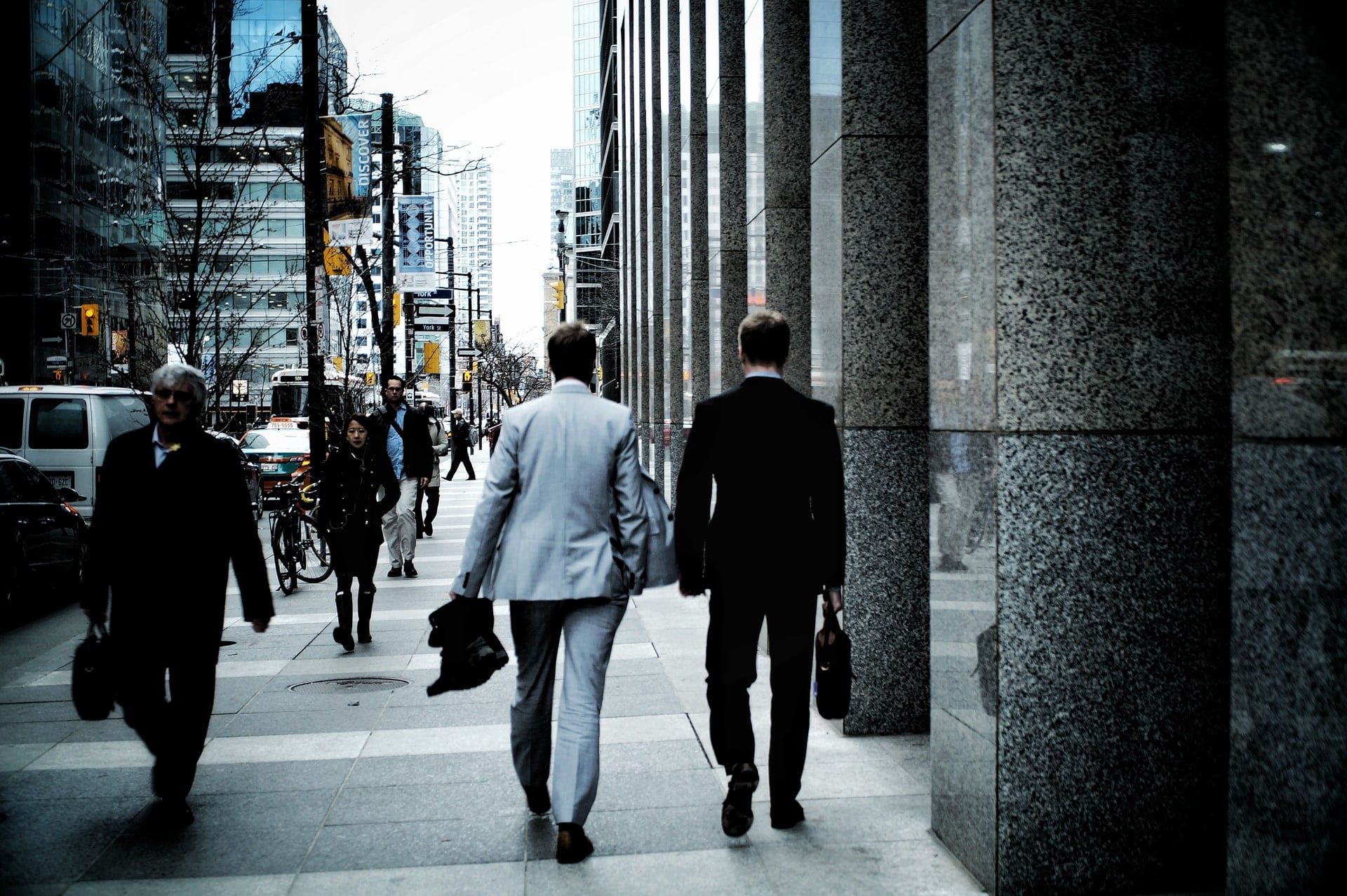 Two men in suits walking on a city street