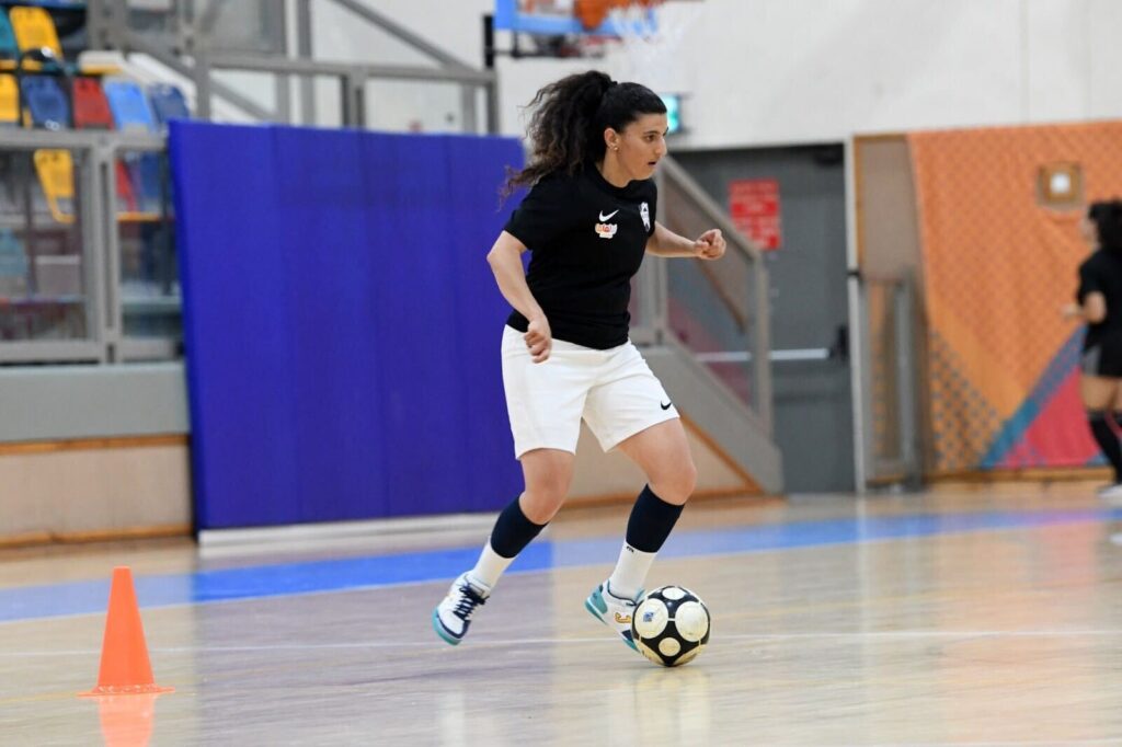 Futsal player kicking ball