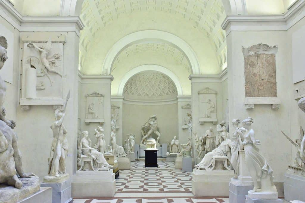a gallery full of white sculptures