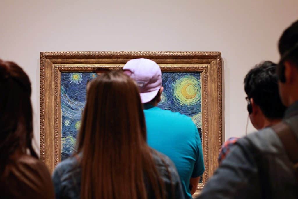 Image of museum visitors viewing painting