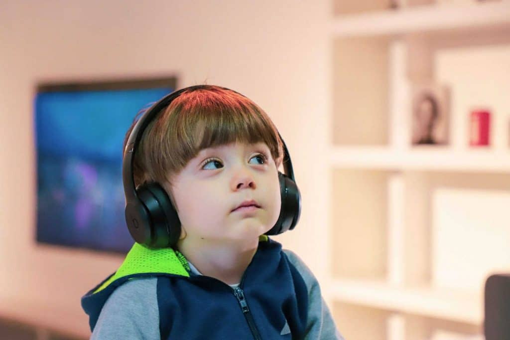 young child wearing a headphone